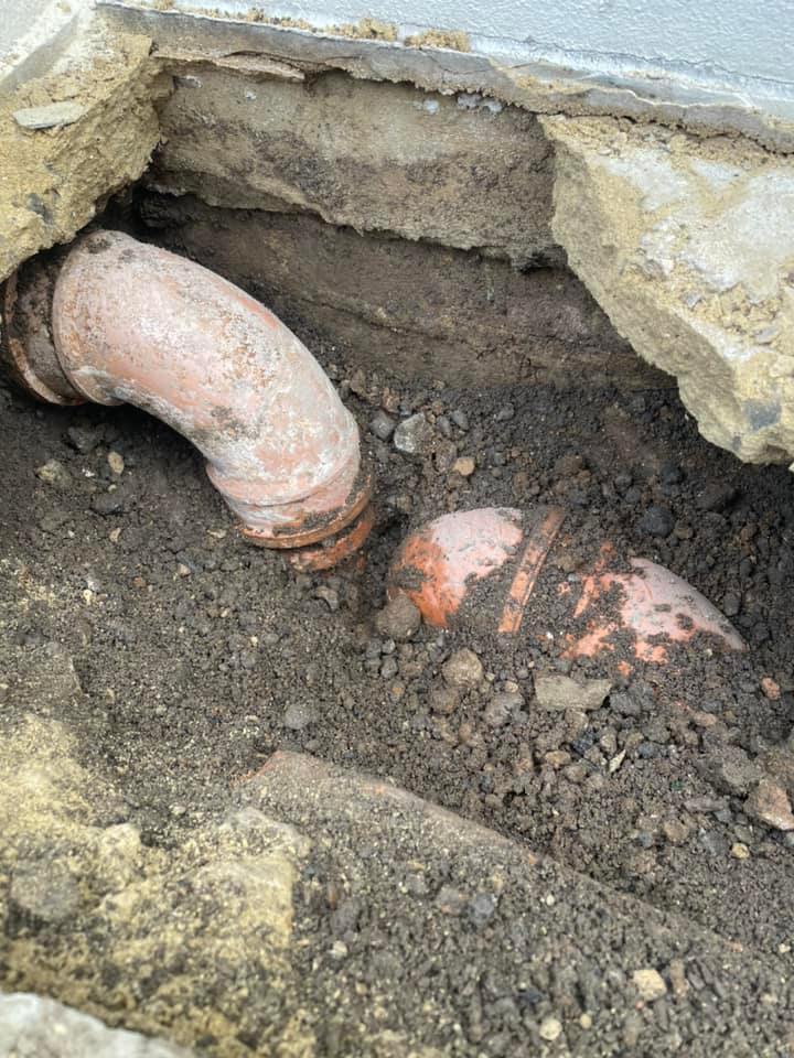 Old, blocked, and overflowing drainage gully needing emergency replacement